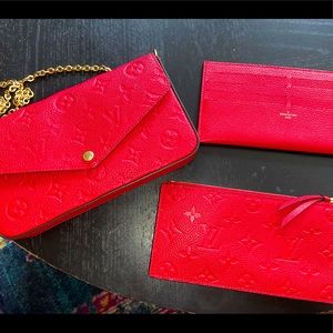 Red leather imprinted Louis Vuitton clutch